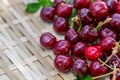 Red cherries on a wooden surface. Juicy cherries in the orchard in a summer day. Sweet fruits. Shallow depth of field. Toned image Royalty Free Stock Photo