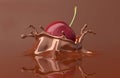 Red cherry falling and splashing into chocolate. Royalty Free Stock Photo