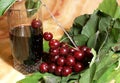 Red cherry and a glass of juice Royalty Free Stock Photo