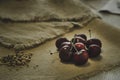 red cherry pile in and ground almonds for sprinkling sweet food on the hemp sack sheet Royalty Free Stock Photo