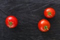 Red cherry tomatoes on black rustic wood background Royalty Free Stock Photo