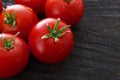 Red cherry tomatoes on black rustic wood background Royalty Free Stock Photo