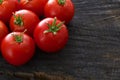 Red cherry tomatoes on black rustic wood background Royalty Free Stock Photo