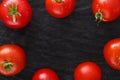 Red cherry tomatoes frame on black rustic wood background Royalty Free Stock Photo