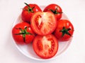 Red cherry tomatoes fruit vine tomato vegetable 
tamaatar tomat timatar pomidor tomate whole and halved closeup view image photo Royalty Free Stock Photo