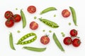 Red cherry tomatoes and green peas on white wooden table. Fresh summer vegetables for food concept, top view, flat lay, banner Royalty Free Stock Photo