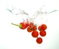 Red cherry tomatoes and paprika under water with bubles on white Royalty Free Stock Photo