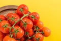 Red cherry tomatoes with stem in antique metallic dish