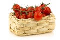 Red cherry tomatoes in a woven basket Royalty Free Stock Photo