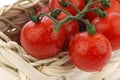 Red cherry tomatoes in a woven basket Royalty Free Stock Photo