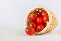 Red cherry tomatoes in a woven basket Royalty Free Stock Photo