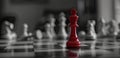 a red chess piece standing victoriously on the board, surrounded by fallen white pieces, with a light gray and blurry Royalty Free Stock Photo