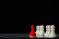 Red chess standing out from white chess on chess board and black background. Leadership concept Royalty Free Stock Photo