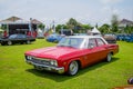 Red Chevrolet Impala four doors hardtop sedan in outdoor car show Royalty Free Stock Photo