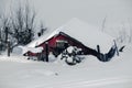 A red chicken barn abandoned and isolated in the cold winter snow Royalty Free Stock Photo