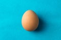 Red, chicken egg on a blue background Royalty Free Stock Photo