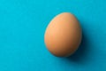 Red, chicken egg on a blue background Royalty Free Stock Photo