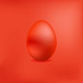 Red chicken egg on a red metallic background. Royalty Free Stock Photo