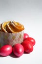 Red chicken eggs and cupcake on a white background. Easter holiday. Royalty Free Stock Photo