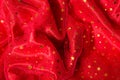 Red chiffon fabric texture. Luxurious birthday background. Christmas and New Year decorations. Golden stars Royalty Free Stock Photo