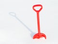 Red childrens shovel into a snow Royalty Free Stock Photo