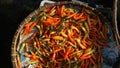 Red chili on a bamboo basket in a traditional market. Exposed to the morning sun.