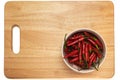 Red chili pepper in a bowl on a wooden cutting board Royalty Free Stock Photo