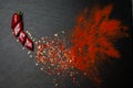 Red chili pepper explosion isolated on black slate board. Copyspace. Top view. Royalty Free Stock Photo