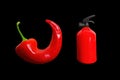 Red chili pepper and fire extinguisher on black Royalty Free Stock Photo