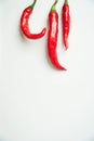 Red chili pepper hangging on white wall for advertisement
