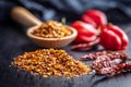 Red chili peppers flakes. Milled spicy peppers on black table Royalty Free Stock Photo