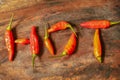 Red chili peppers isolated on wood chopping board Royalty Free Stock Photo