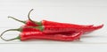 Red Chili Peppers over white table background Royalty Free Stock Photo