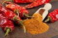 Red chili peppers and pile of ground chilly Royalty Free Stock Photo