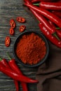 Red chili peppers and powder on rustic wooden background Royalty Free Stock Photo