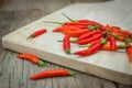 Red chili Peppers on wood chopping background Royalty Free Stock Photo