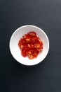 Red chili slices on dark background