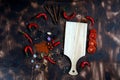 red chili and tomato, salt, garlic, rosemary on a dark wooden background ingredients for cooking cover cookbook asian cuisine,