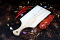 red chili and tomato, salt, garlic, rosemary on a dark wooden background ingredients for cooking cover cookbook asian cuisine,