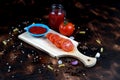 red chili and tomato, salt, garlic, rosemary on a dark wooden background ingredients for cooking cover cookbook asian cuisine,