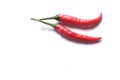 Close up three red hot chili peppers on a white background.