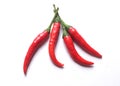 Close up three red hot chili peppers on a white background.