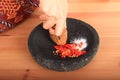 Red chilli paprikas and salt smashed in mortar Royalty Free Stock Photo