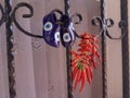 Red chilli peppers drying by window with blue charm shoes