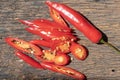 Red chilli peppers slices over wooden background, top view. Hot and spicy ingredients cooking concept