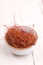 Chilli threads in a bowl on a white shabby background Royalty Free Stock Photo