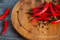 Red chilly peppers on a round wooden board Royalty Free Stock Photo