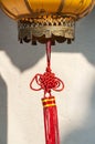 Red Chinese knot decoration attached to a traditional lantern