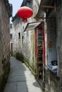 A red Chinese lantern hangs outside a small alley shop in Hongcun, China