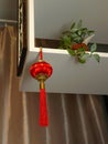 A red Chinese lantern with a tassel hangs from the ceiling, viewed from below Royalty Free Stock Photo